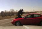 米警官、容疑者の車のボンネットに乗り、銃を構える【動画】